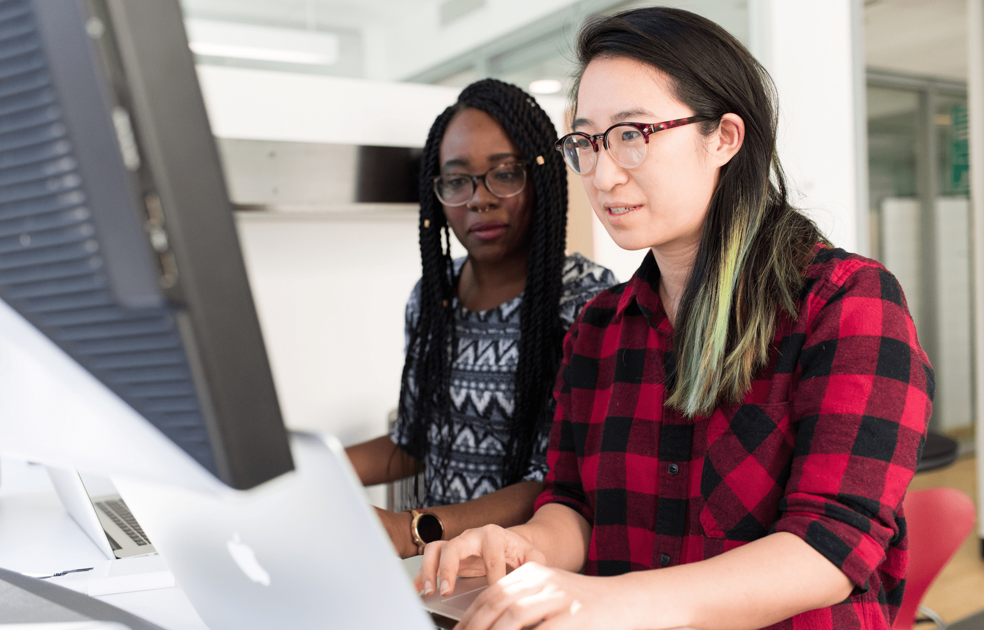 Two young women collaborating in an office setting