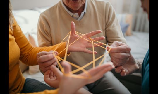 Family plays cat's cradle