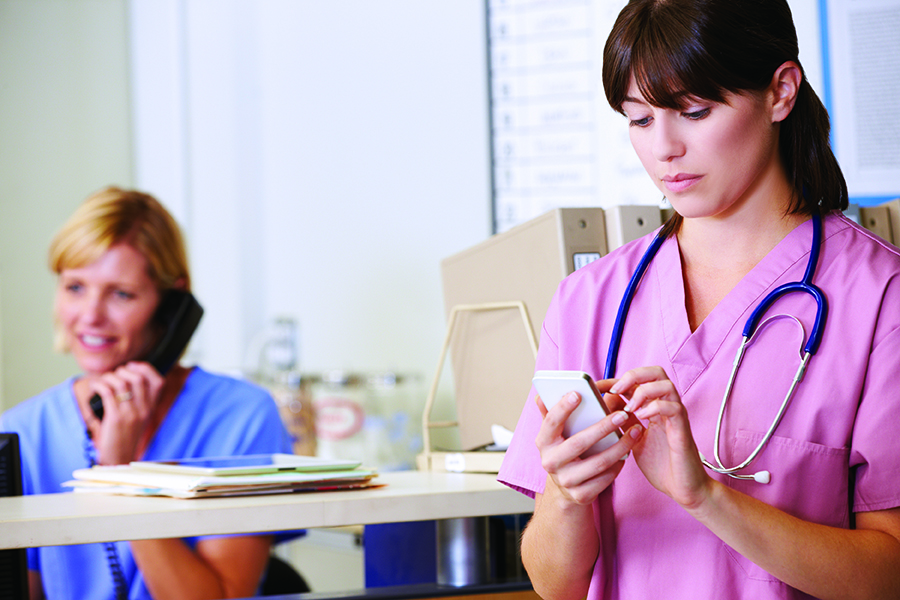 Nurses using phones to communicate with clients