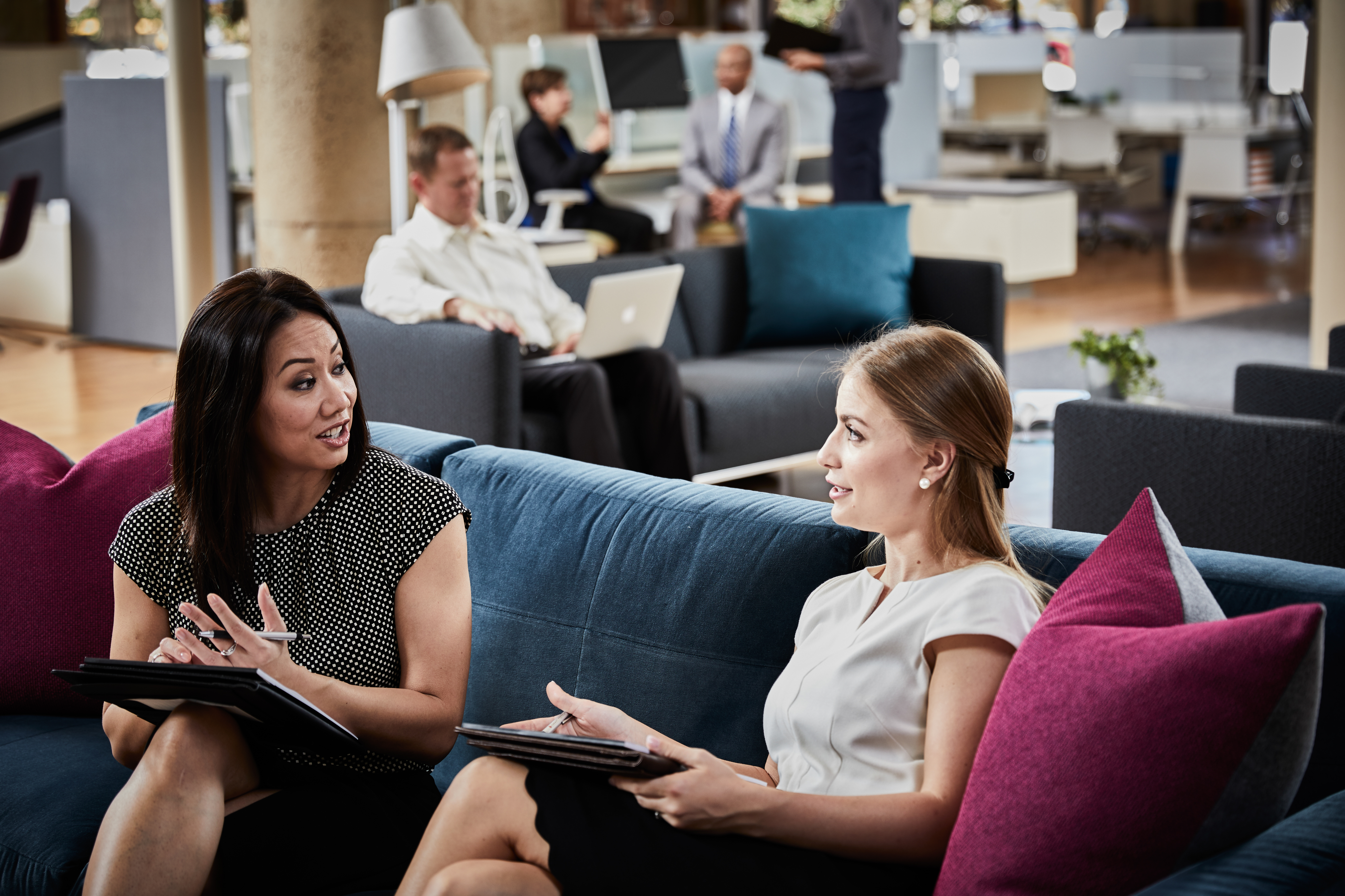 Associates having a conversation while sitting on a couch