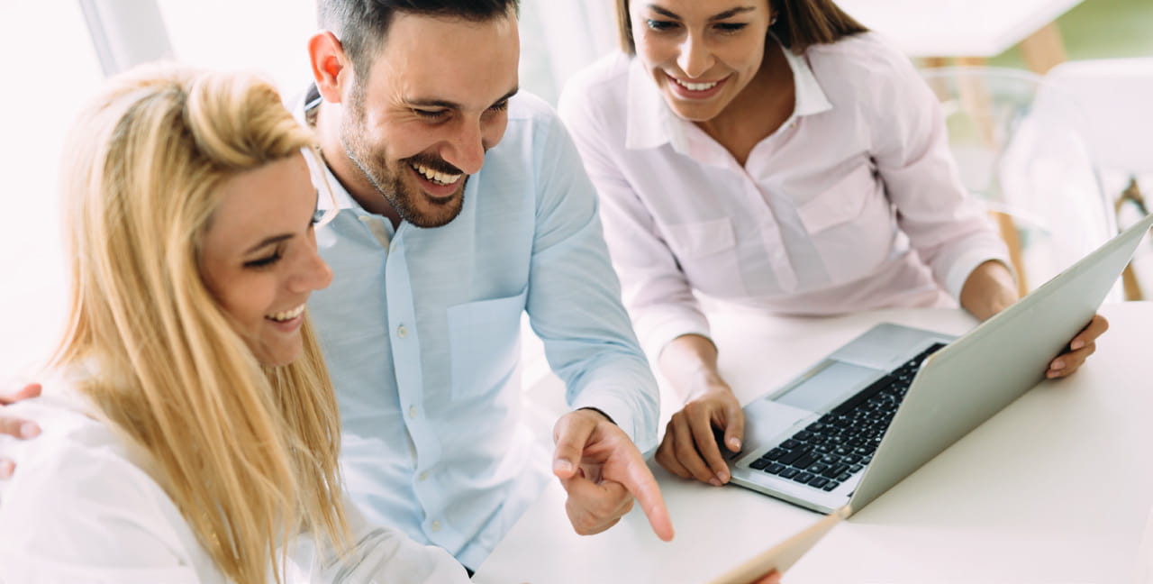Group of people viewing laptop